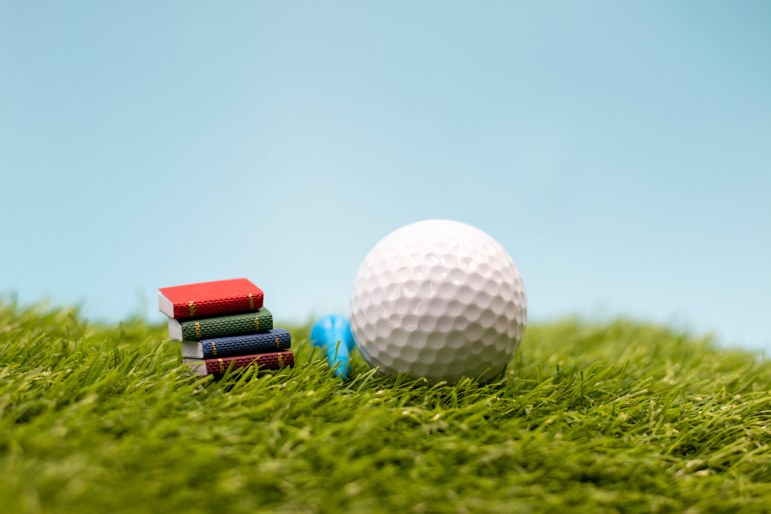 Golf,Ball,With,Book,Of,Rules,Is,On,Green,Grass