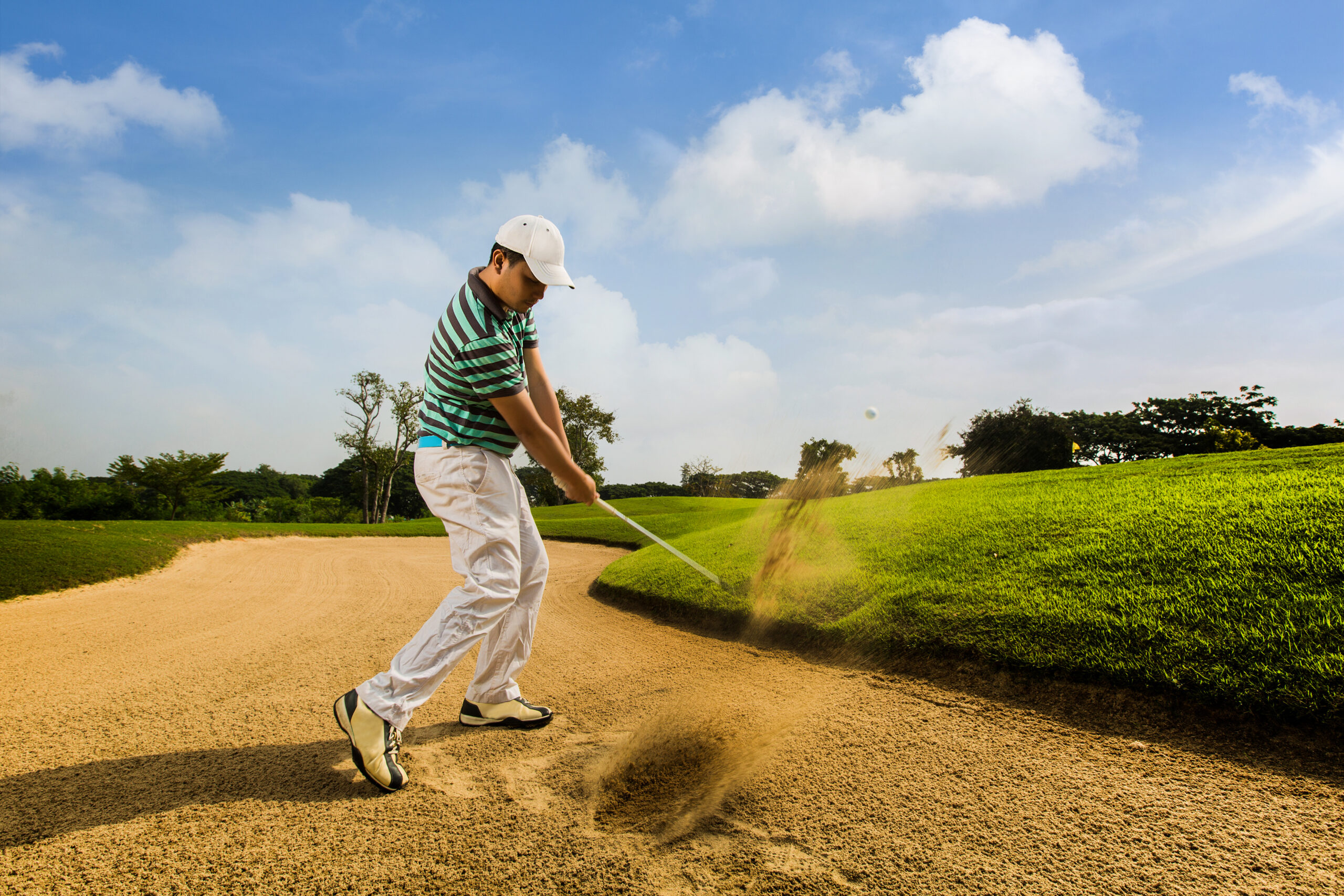 Golfer,Hitting,The,Ball,On,The,Sand.,Speeds,Cause,Blurred