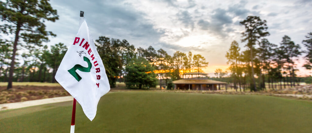 Golf flag with number 2 trees in the background